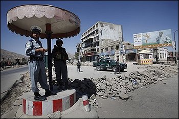 Afghan police guard a security checkpoint made from a pile of rocks in downtown Kabul, Afghanistan, Wednesday, Aug. 19, 2009, on the eve of the presidential elections. (AP Photo/David Guttenfelder)